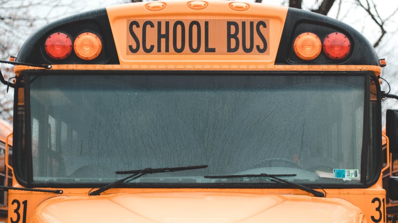 A close up of the front of a school bus, representing common law notice of dismissal without cause