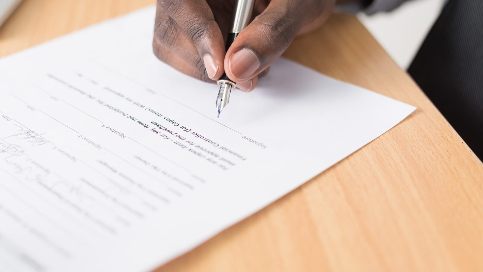 person signing contract representing new life insurance policy