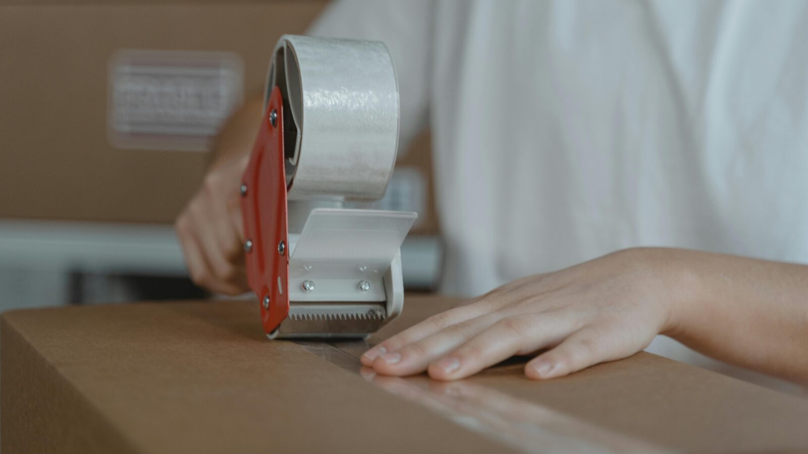 Photo of person taping up a packing box representing family property division following a divorce