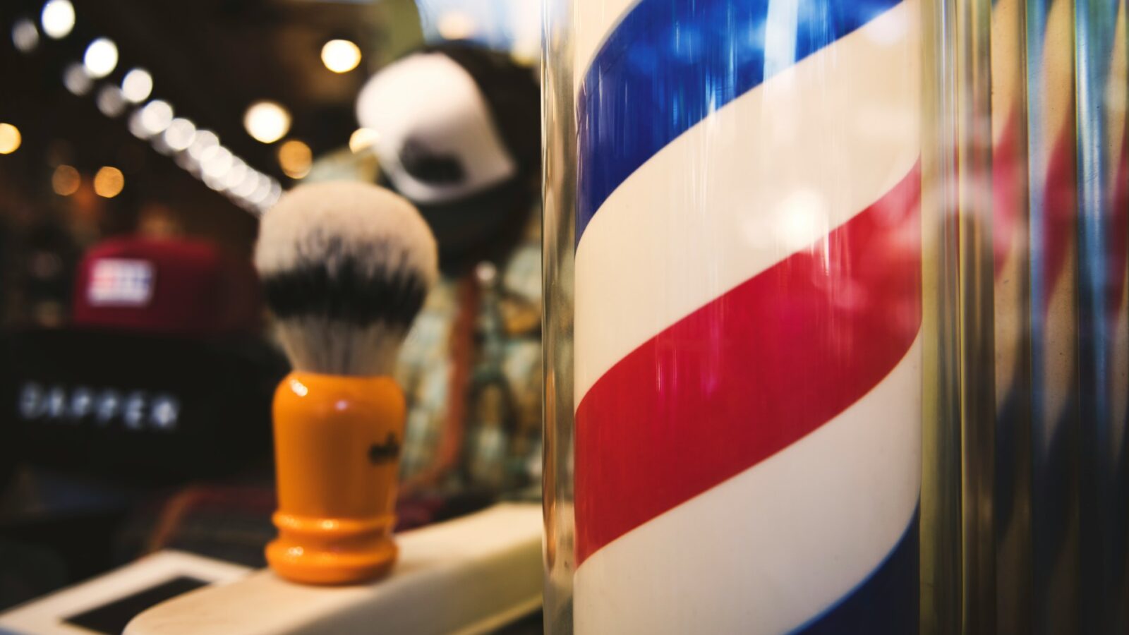 Close up view of a barbershop pole with a shave kit in the background, representing progressive discipline and wrongful dismissal in Windsor-Essex County employment law