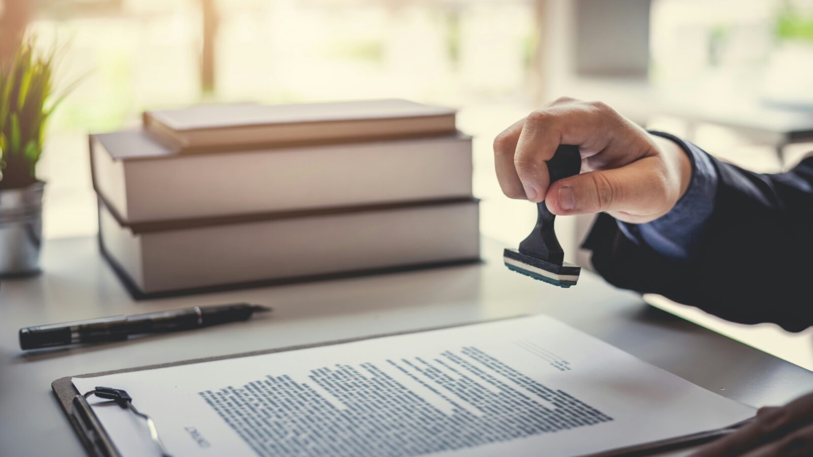 A man stamping a document.