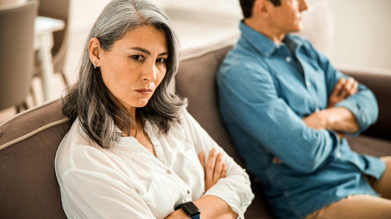 A middle-aged woman and man having a disagreement, representing high-conflict families and estate planning in Alberta.