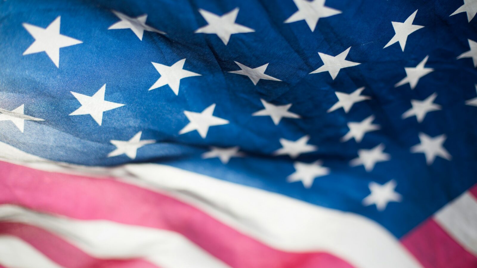 Close-up of the US flag, representing contracting with cross-border businesses in Alberta