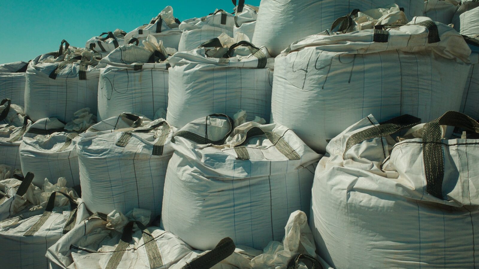 Rows of sandbags, representing sandbagging and anti-sandbagging clauses in Alberta business deals